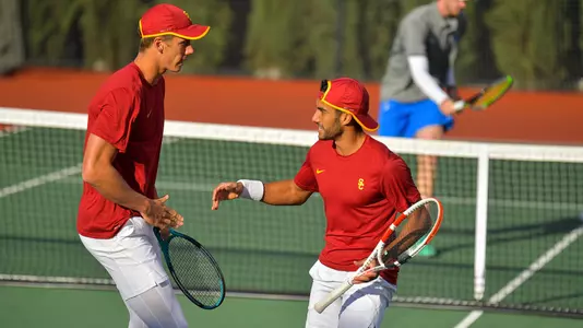 Riley Smith and Daniel Cukierman cheer each other on in doubles vs UCLA