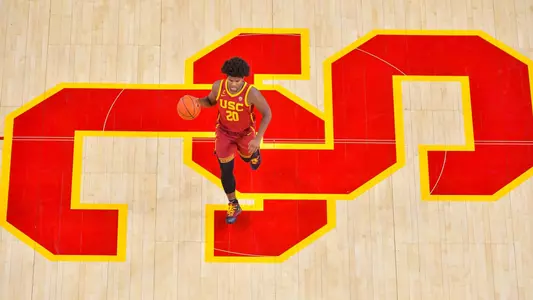 Ethan Anderson dribbling on logo from above