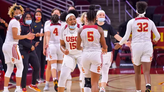 USC women's basketball players congratulate each other during a win over ASU.