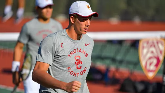 Riley Smith at the net in a USC home match