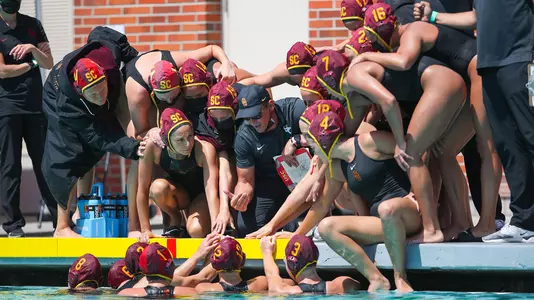 Marko Pintaric and the team huddle up during a game at Uytengsu Aquatics Center