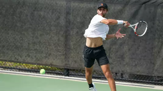 Stefan Dostanic hits a big forehand in the NCAA Round of 16 in Orlando