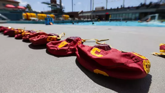 Game caps are lined up on the pool deck before a game at Uytengsu Aquatics Center