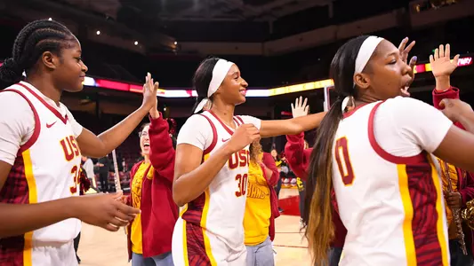 USC players go through the high five line with the USC band