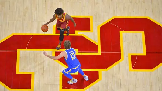 Anderson dribbles against UCLA on USC Logo