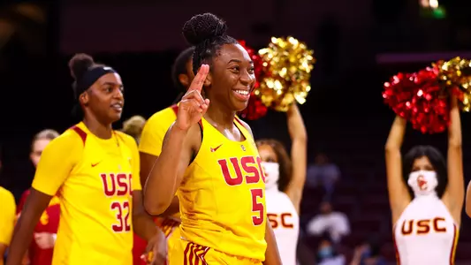Jordan Sanders smiles and shows a fight on symbol after a win at Galen Center