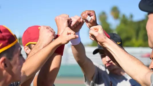USC players put their fists up for a cheer at Marks Stadium