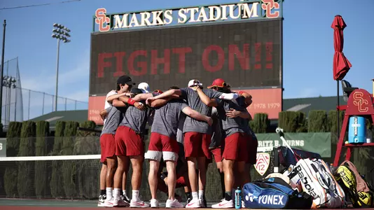 The USC team huddles up in front of the scoreboard before a win over UCLA at Marks Stadium