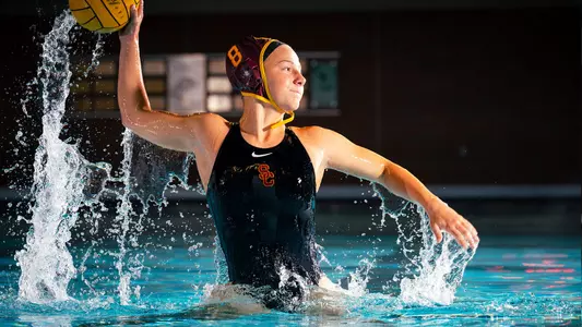 Julia Janov rises up with the ball during a photo shoot at Uytengsu Aquatics Center.