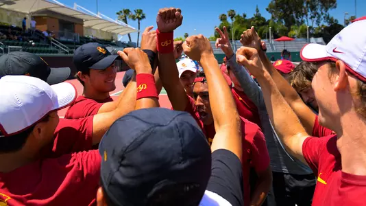 USC players huddle up for a cheer before an NCAA match at Marks Stadium