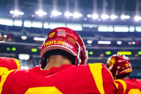 A Trojan football player takes the field.