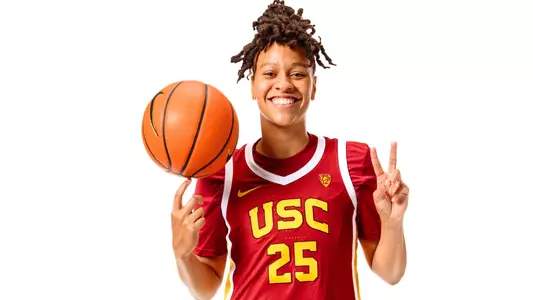 McKenzie Forbes spins the ball on her finger and flashes a fight on in a photo shoot