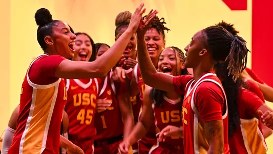 USC players cheer and high-five during a media day video shoot