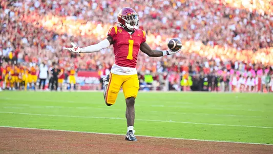 Zachariah Branch celebrates in the end zone after scoring a touchdown.