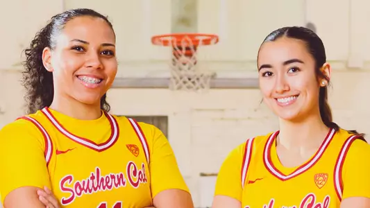 Destiny Littleton and Alyson Miura pose together in gold uniforms