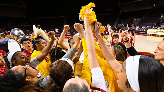 USC players celebrate after beating WSU in double overtime at Galen Center