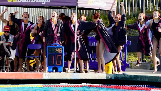 The USC bench cheers as the Trojans secure an overtime win over UCLA at the Triton Invitational
