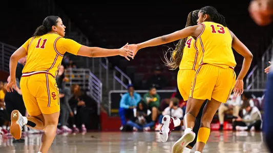 Destiny Littleton and Rayah Marshall give each other five during a game at Galen Center