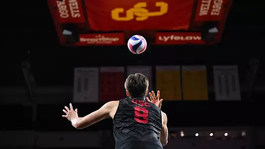 Kyle Paulson tosses ball to serve