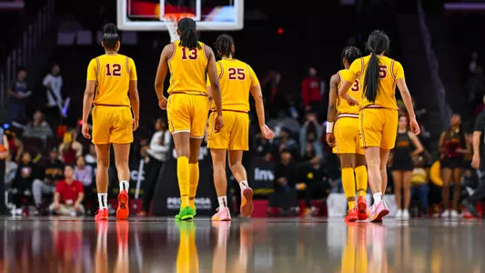 USC players on court with backs to camera at Galen Center