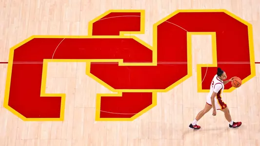 JuJu Watkins dribbles across the USC logo during a game at Galen Center