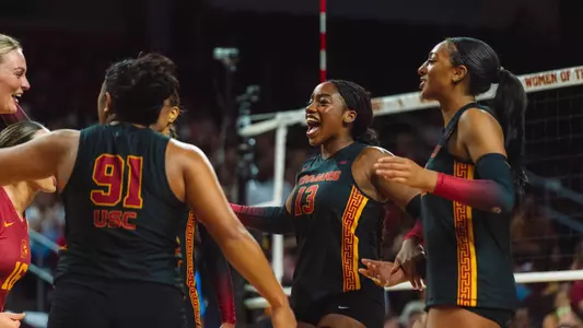 Team huddles and celebrates with Tyrah Ariail