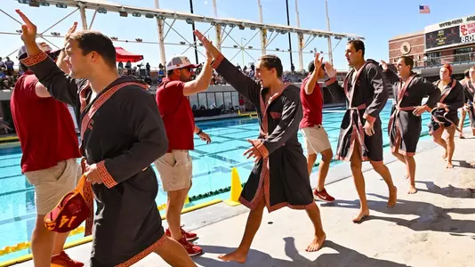 Team high fives on pool deck