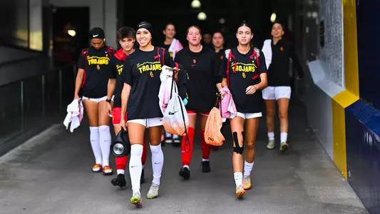 USC women's soccer players in warmup gear at Dignity Health Sports Park Main Stadium exiting the tunnel to the field.