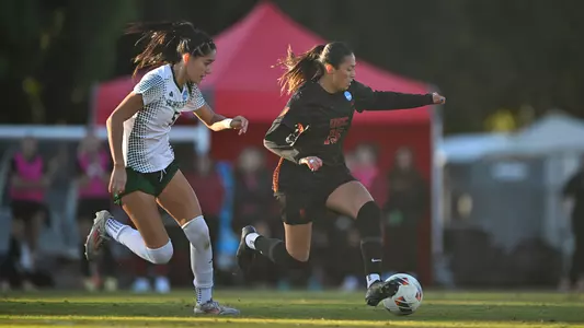 Maribel Flores dribbles against a Sacramento State defender during USC's NCAA Tournament opening round victory.