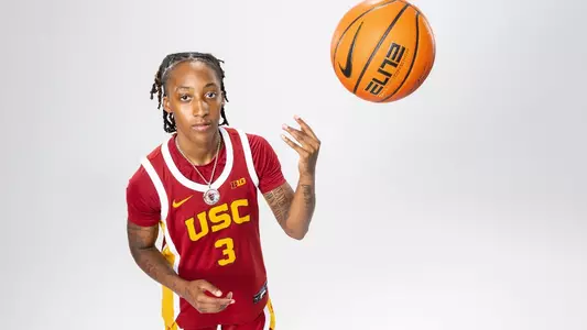 Aaliyah Gayles tosses a basketball in the air during a photo shoot.