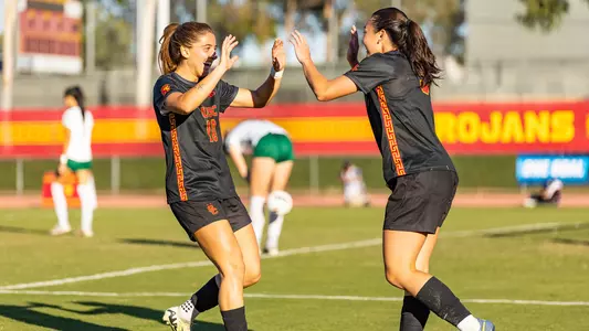 Maria Alagoa and Maile Hayes high five during USC's NCAA first round win over Sacramento State.