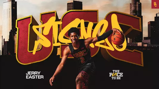 Jerry Easter dribbles a basketball with the words USC and signed behind him.