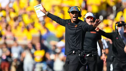 D'Anton Lynn calls out to his players on the field.