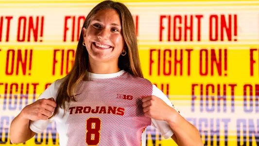 Sophia Cavaliere recruiting photoshoot shot in front of a video board that says Fight On!