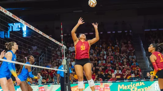USC women's volleyball senior setter Mia Tuaniga jumps to set a ball for redshirt freshman middle blocker Leah Ford during the crosstown rivalry match with UCLA at the Galen Center.