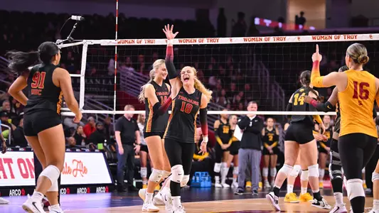 USC women's volleyball graduate transfer defensive specialist/outside hitter Grae Gosnell celebrates a Trojan point with her hand up in the air as Gala Trubint points at her on the Galen Center Taraflex during a 3-0 win over Iowa on Senior Night.