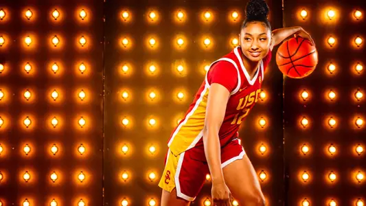 JuJu Watkins dribbles the ball and smiles during a photo shoot