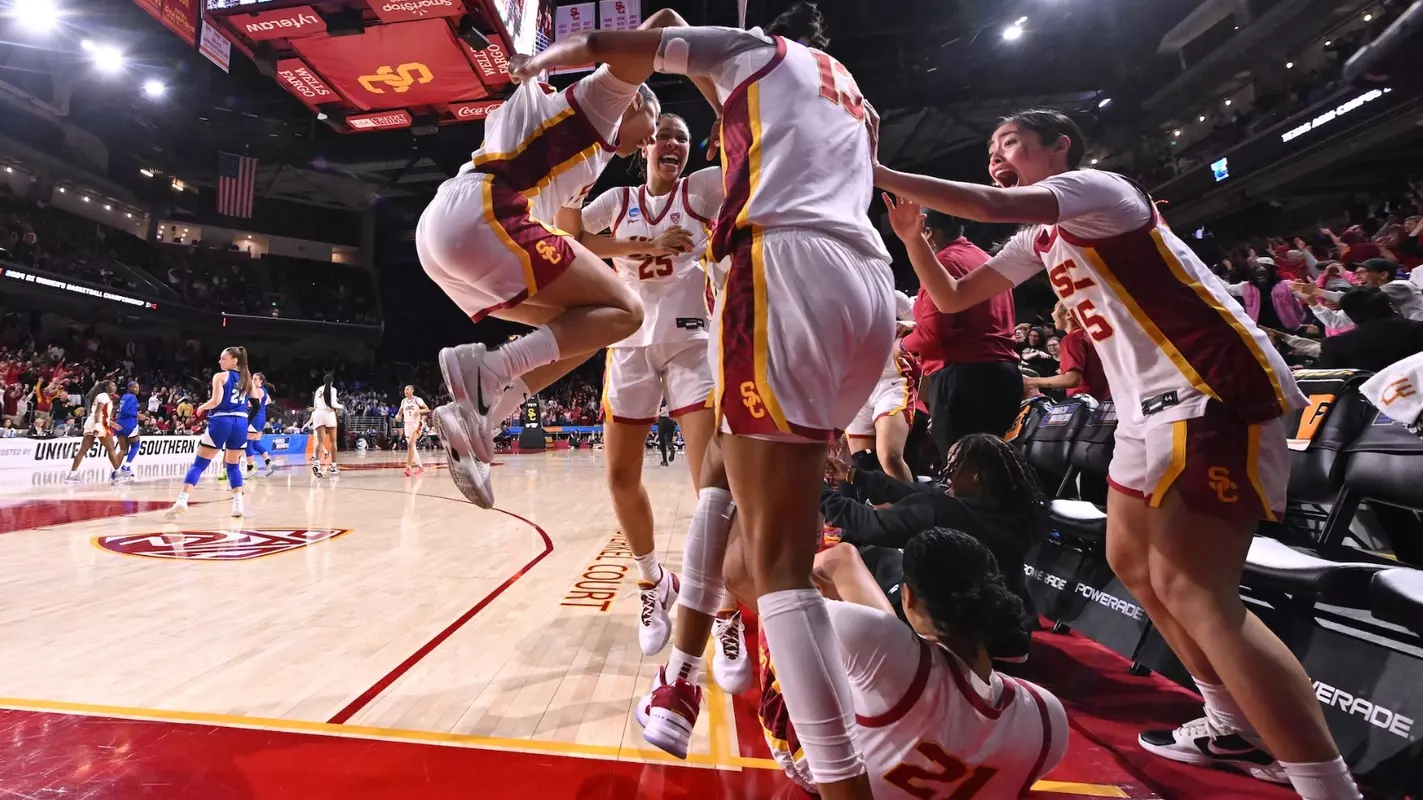 USC players celebrate during NCAA First Round win at Galen Center
