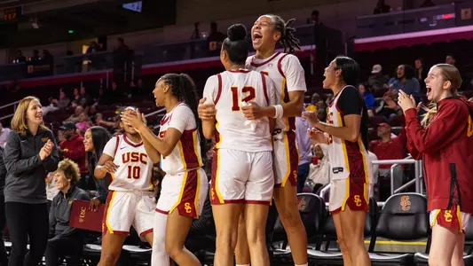 USC bench cheers during a win at Galen Center