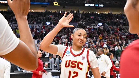JuJu Watkins high fives teammates after USC's Sweet 16 win over Baylor