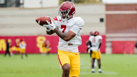 Kamari Ramsey looks the ball into his hands at practice.