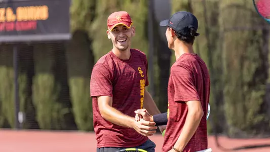 Peter Makk shaking Connor Church's hand at practice