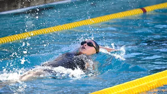 USC swimmer is captured in the pool swimming backstroke.