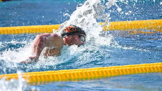 Trojan breathes while swimming freestyle in pool.