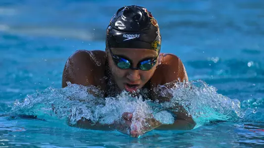 Girl swimming breaststroke takes a breathe.