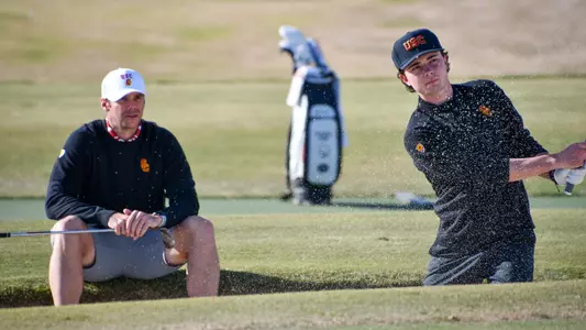 Coach Kolton Lapa coaching Jack Jerge as he hits from the bunker