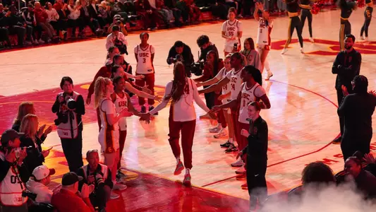 Kiki Iriafen takes the court during starter introductions before a game at Galen Center