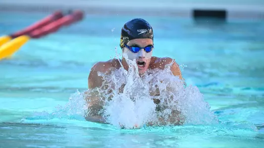 Chris O'Grady takes a breathe while  swimming breaststroke.