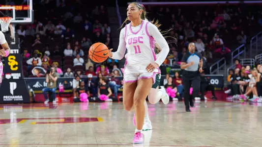 Kennedy Smith dribbles a ball down the basketball court.