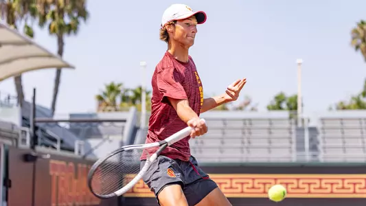 Niels Hoffmann hits a return on tennis court